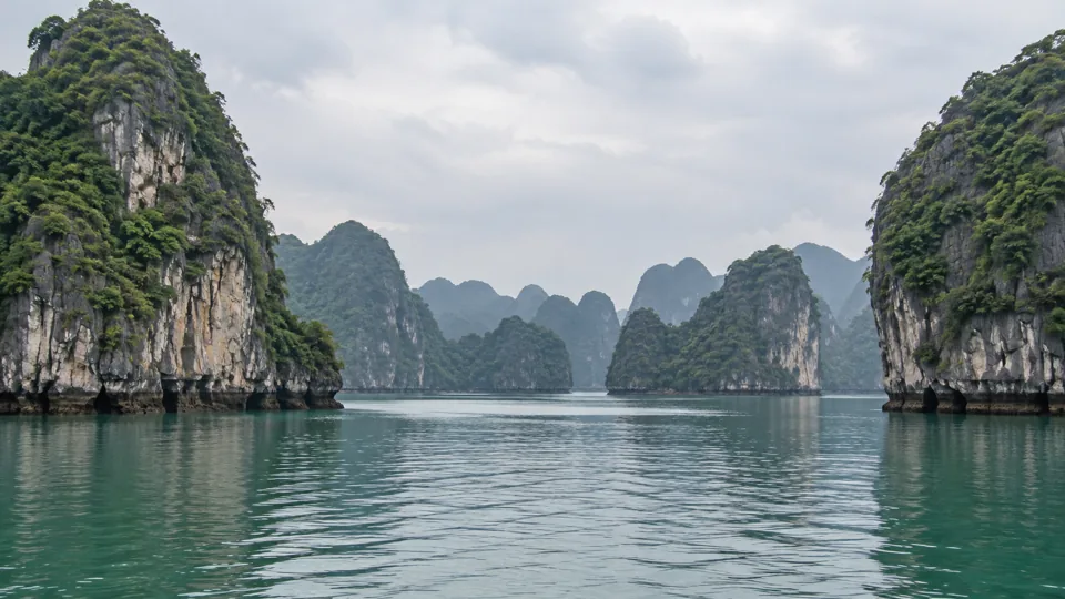 Limestone karst islands rising from the water in Ha Long Bay, Vietnam