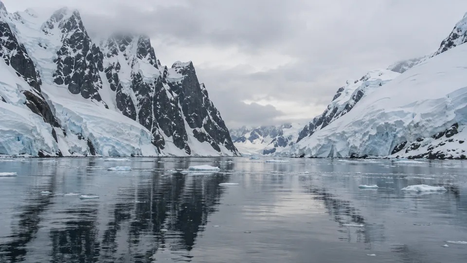 Floating ice and steep snowy peaks in the Lemaire Channel, Antarctica