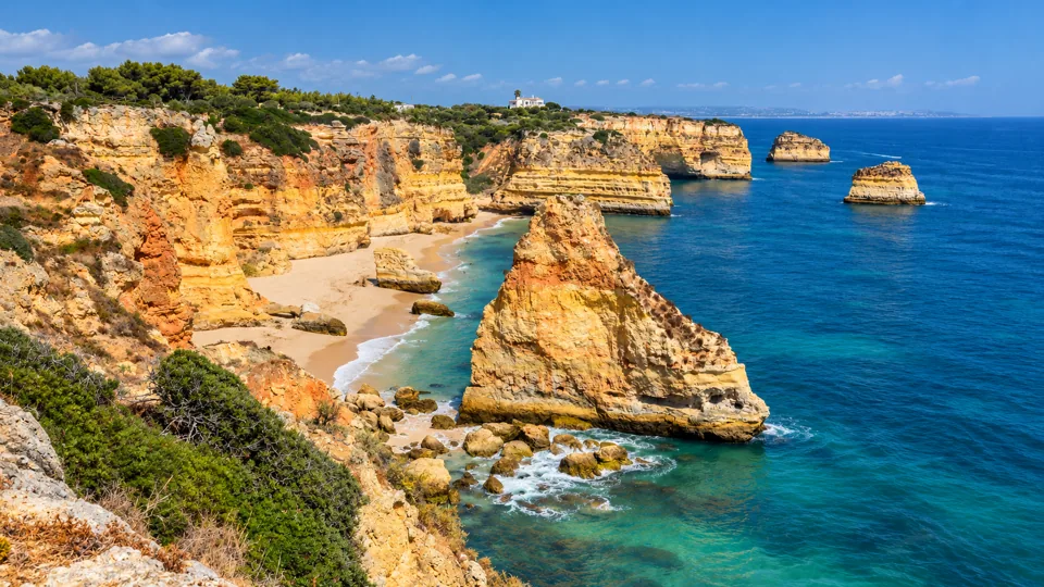 Golden limestone cliffs and sea arches at Praia da Marinha