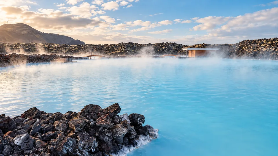 Milky blue geothermal water amid black lava