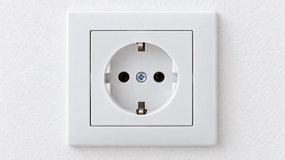 A real recessed Type F round wall socket with side earth clips