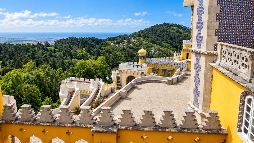 Red and yellow Pena Palace terraces above forest