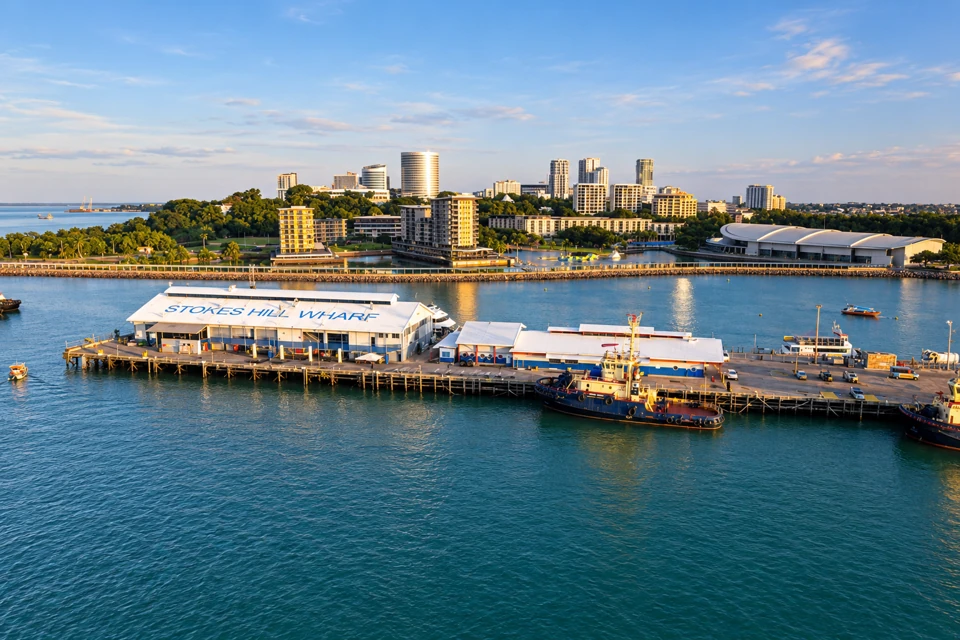 Stokes Hill Wharf sheds and harbour in front of Darwin waterfront park and city skyline