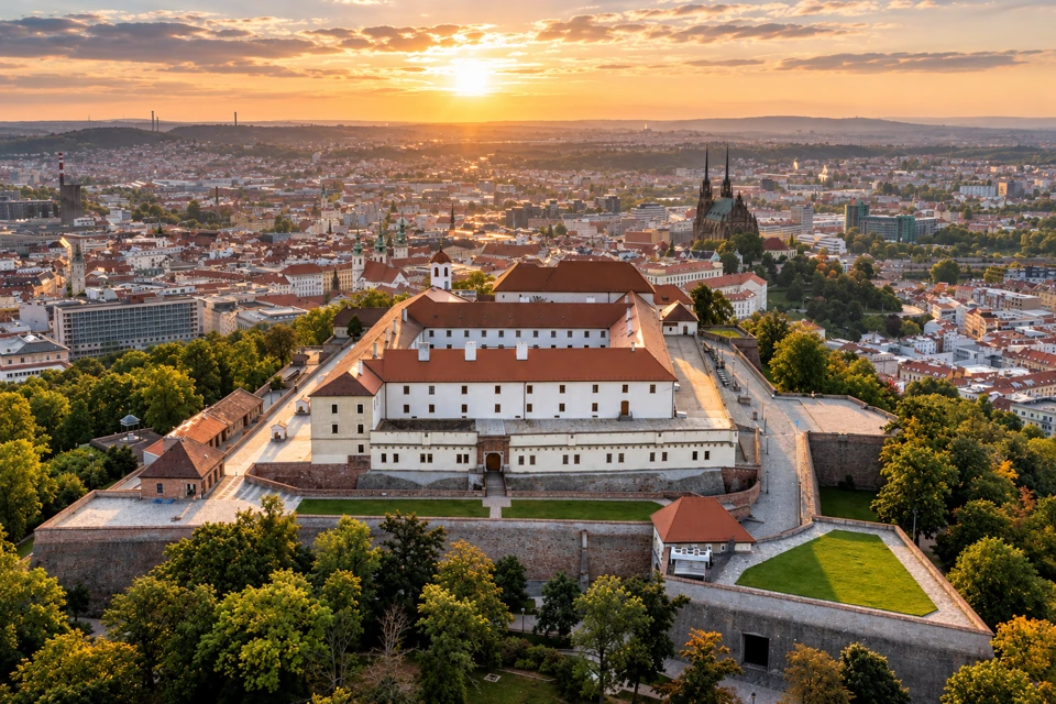 Špilberk Castle's white courtyard buildings, terracotta roofs and angular bastions above Brno.