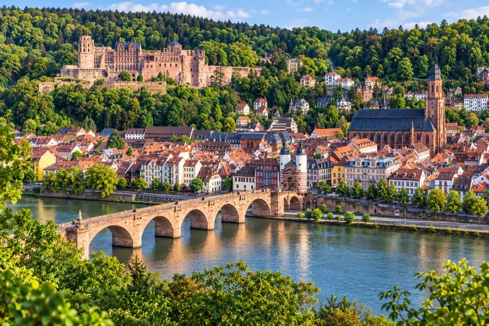 Heidelberg's Old Bridge over the Neckar, red-roofed old town and castle above the river.