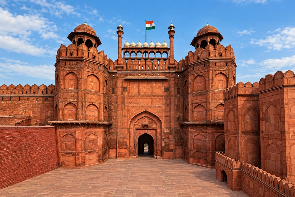 The Red Fort's Lahori Gate in Delhi, with red sandstone towers and domed pavilions.