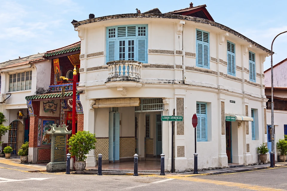 White shophouse with pale blue shutters at Lebuh Armenian and Lebuh Cannon in George Town, Penang.