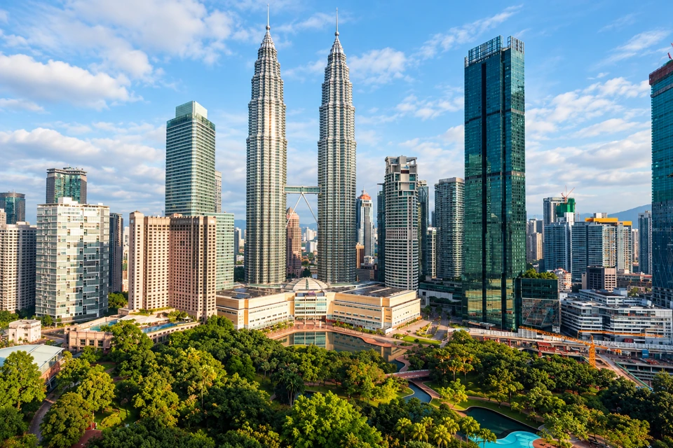 The Petronas Twin Towers and skybridge above KLCC Park in Kuala Lumpur.