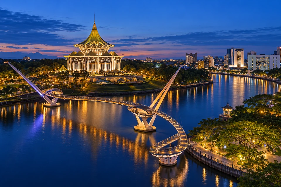 Darul Hana Bridge curves across the Sarawak River in Kuching, with the State Legislative Assembly beyond.