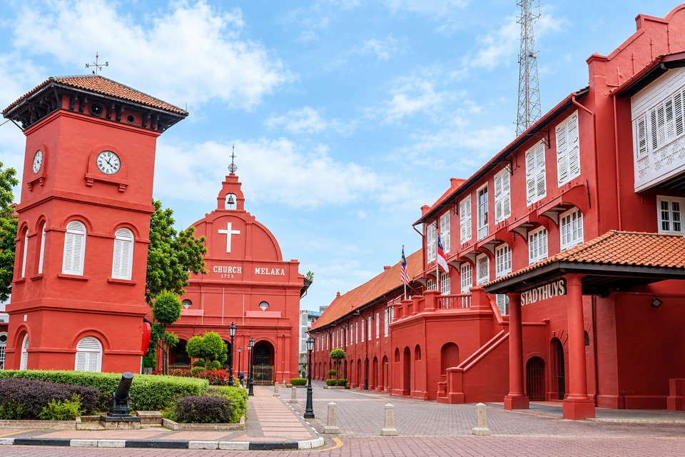 Red clock tower, Christ Church and the white-shuttered Stadthuys at Dutch Square in Melaka.