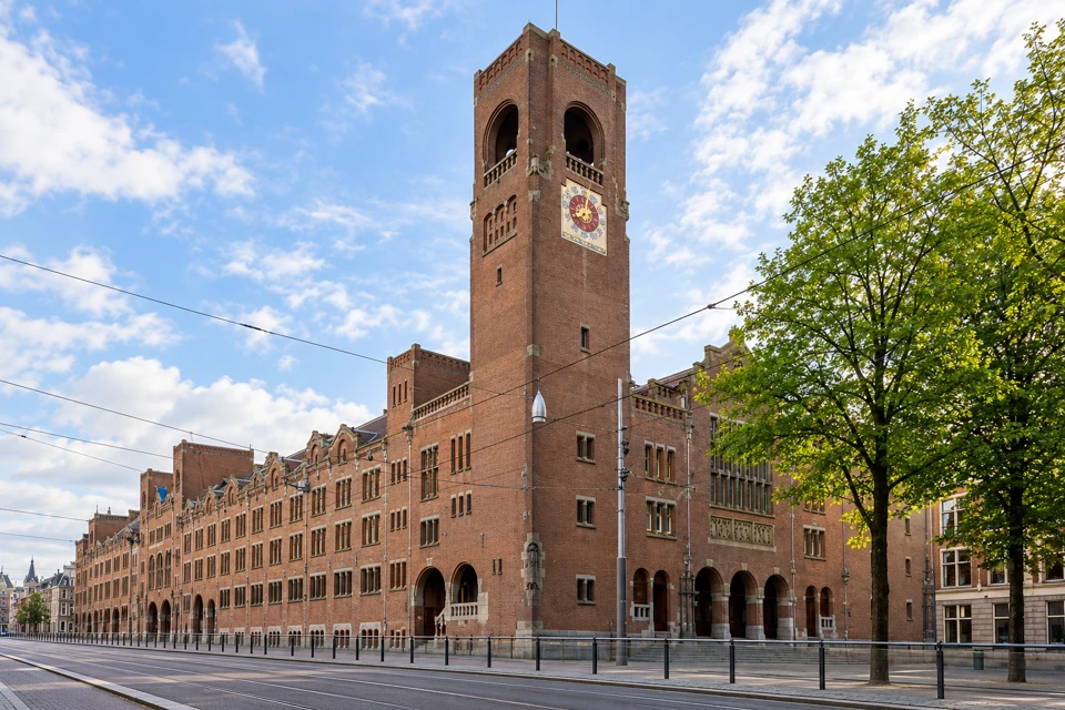 The Beurs van Berlage's red-brick clock tower and long facade on Amsterdam's Damrak.