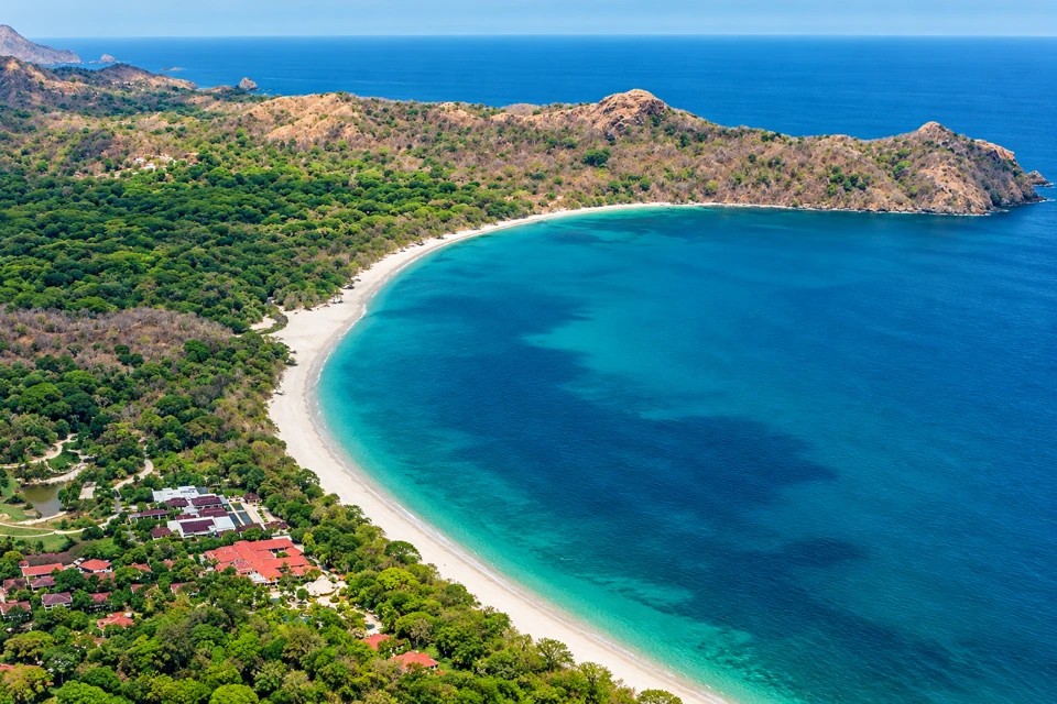 Playa Conchal's crescent of pale shell sand and rounded coastal headland in Guanacaste.