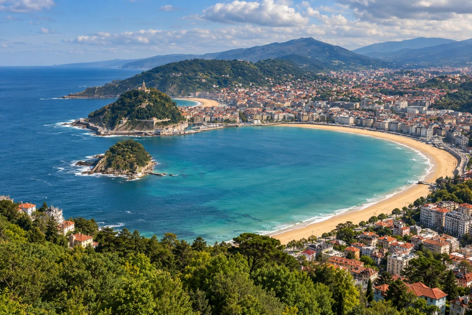 San Sebastian's La Concha Bay with its curved beaches, Santa Clara island and green Basque hills.